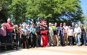 Pouncer cuts a ribbon at the Thread dedication