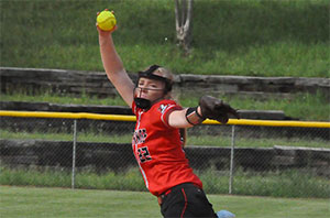 Softball pitcher throws a ball