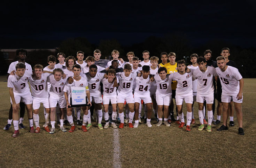 Men's soccer team poses for a group photo after the championship game