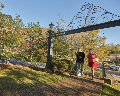 Students walking past the arch