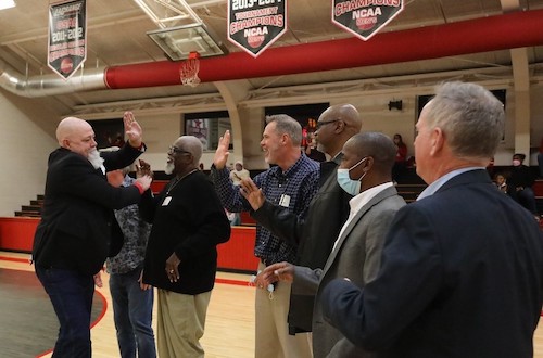 Members of the 1982-83 championship team greet each other on the court.