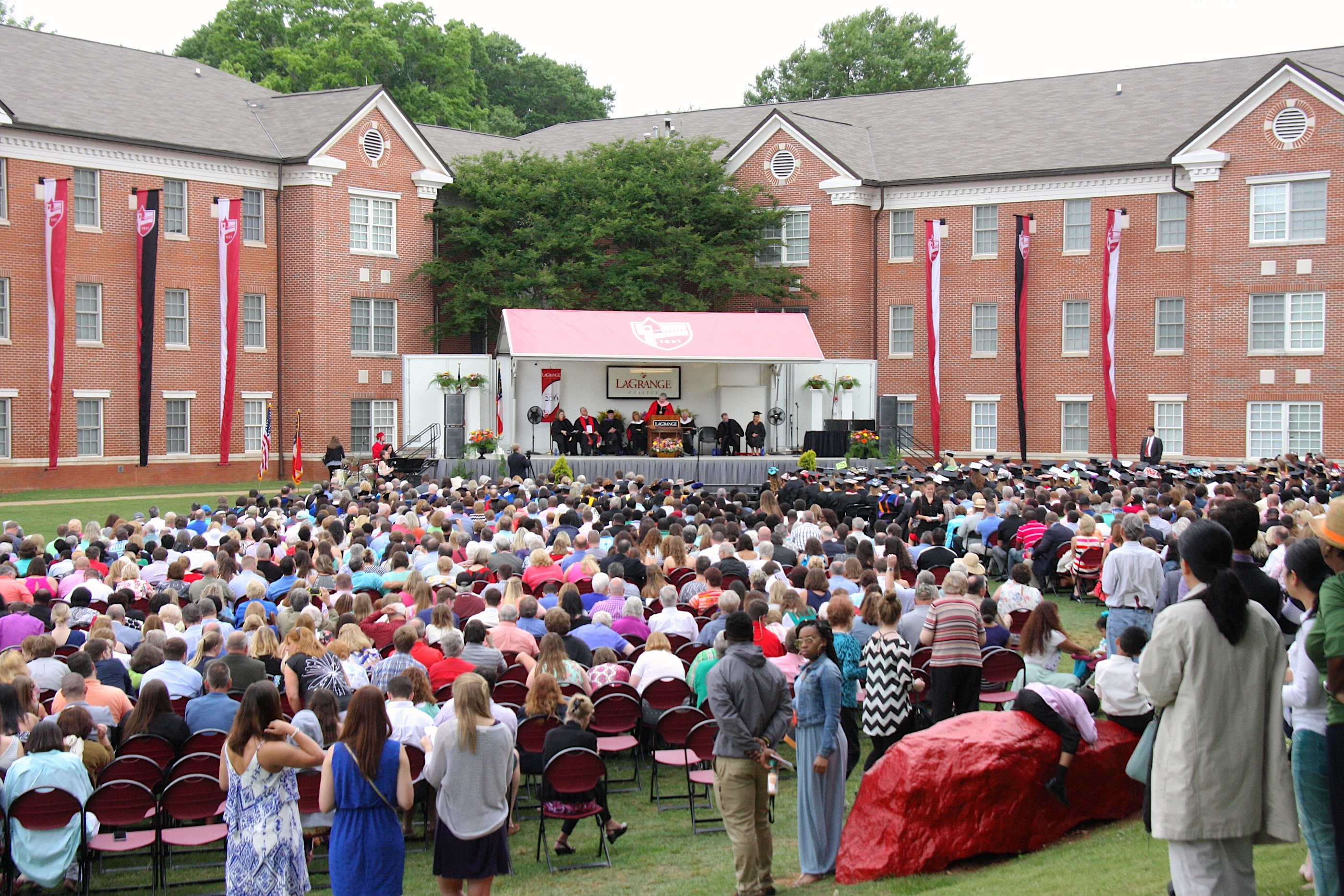 Students, faculty and friends watch a commencement ceremony