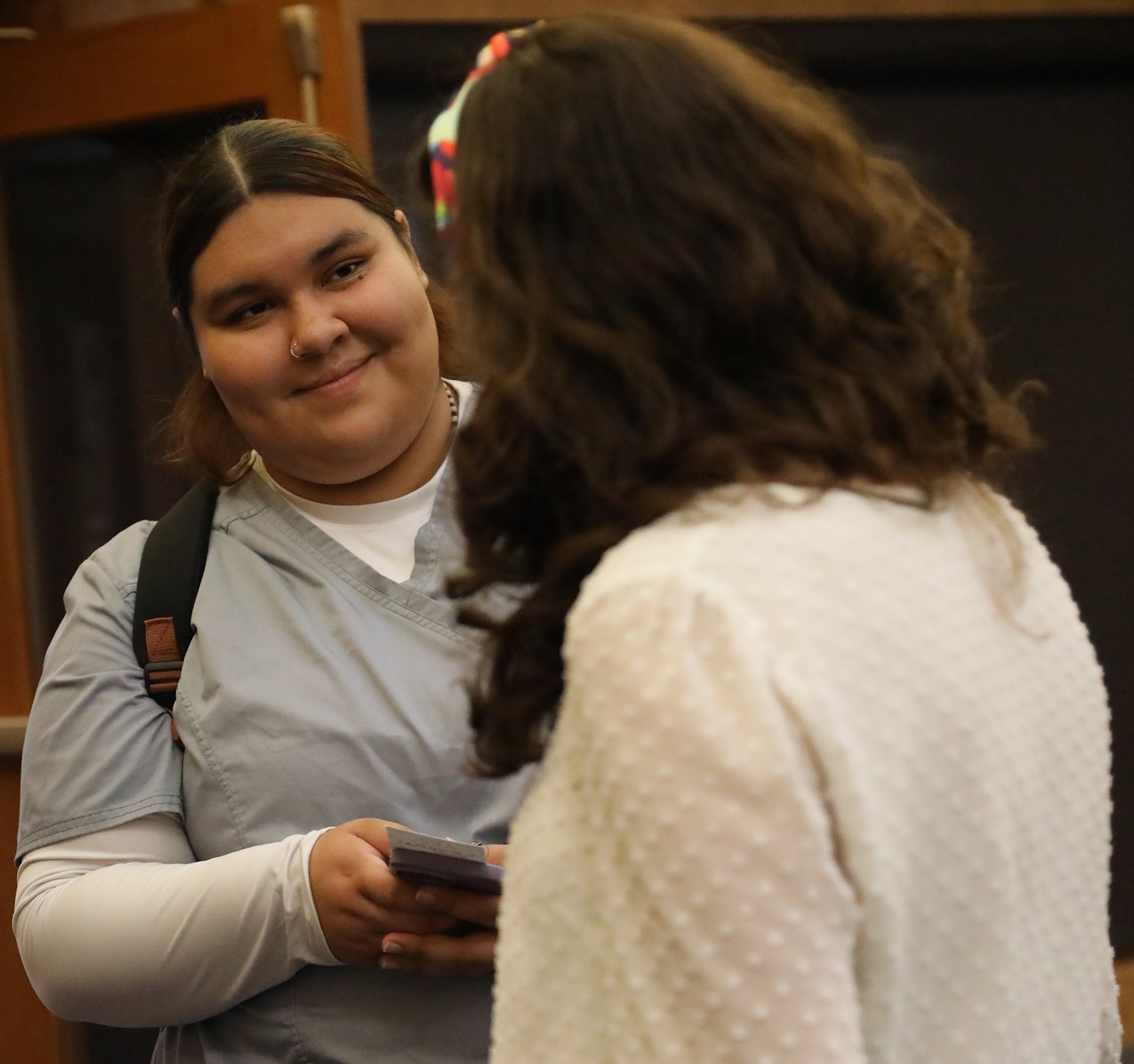 Nursing student speaking with instructor.