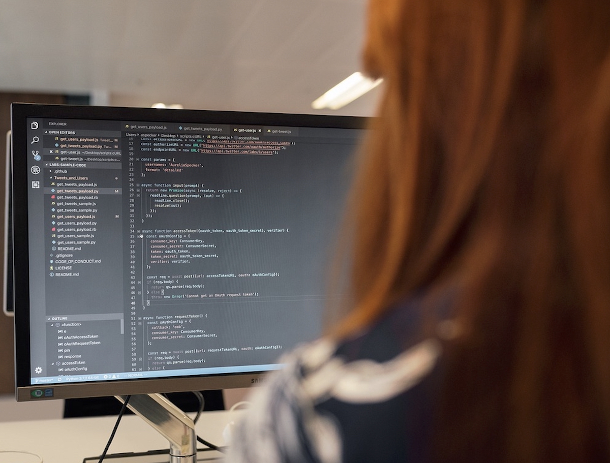 A student looks at a computer screen full of code
