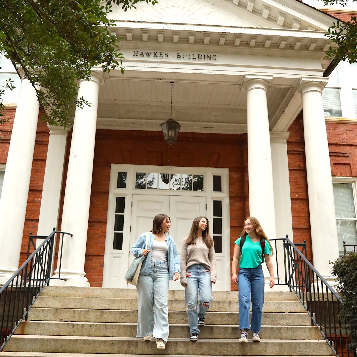 Students carrying their possessions into Hawkes Hall on move-in day